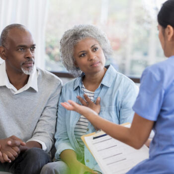 Doctor discusses health concerns with senior couple